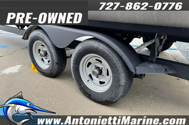 Slide: The Image of Pre-owned 2022 Sun Tracker 22 Sport Fish DLX trailer with contact details and website. - 28