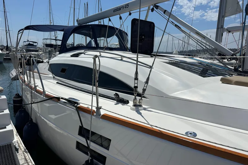 Slide: The Image of 2018 Elan 45 Impressions yacht docked in a marina under a clear blue sky. - 10