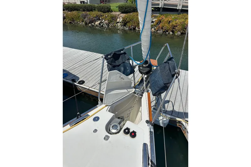 Slide: The Image of 2018 Elan 45 Impressions sailboat bow with anchor chain and dock view. - 16