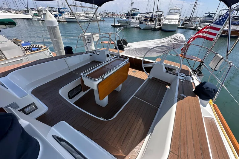 Slide: The Image of Cockpit of 2018 Elan 45 Impressions yacht docked at marina with American flag. - 23