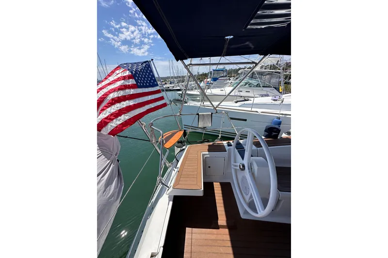 Slide: The Image of Sailing yacht Elan 45 Impressions 2018 with American flag, docked in marina. - 28