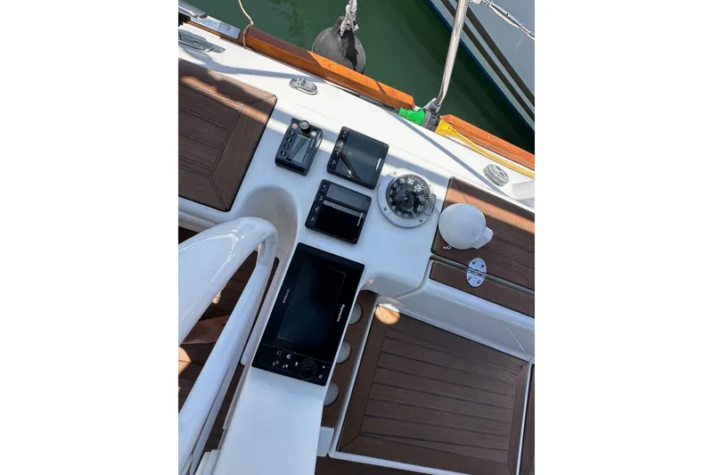 Slide: The Image of Cockpit of 2018 Elan 45 Impressions yacht with navigation instruments and wooden accents. - 30