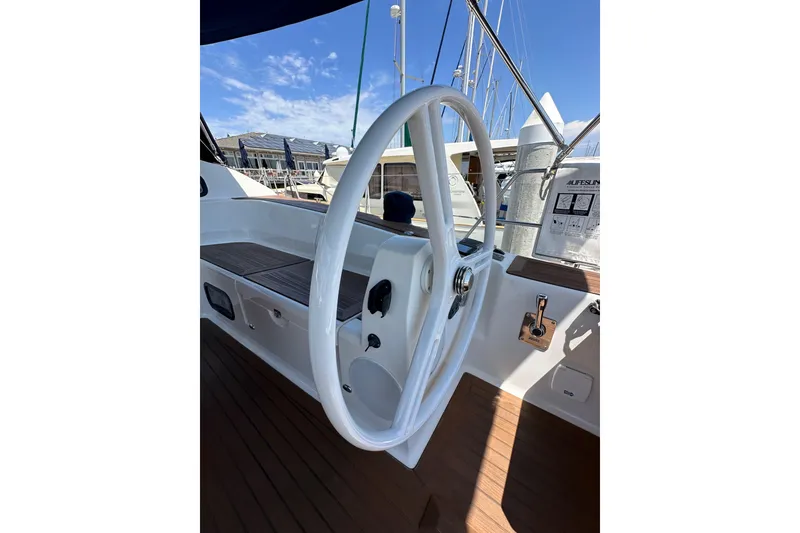Slide: The Image of Steering wheel of 2018 Elan 45 Impressions yacht, docked under clear blue sky. - 31