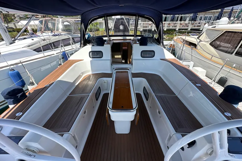 Slide: The Image of 2018 Elan 45 Impressions yacht cockpit with wooden seating and steering wheel. - 35