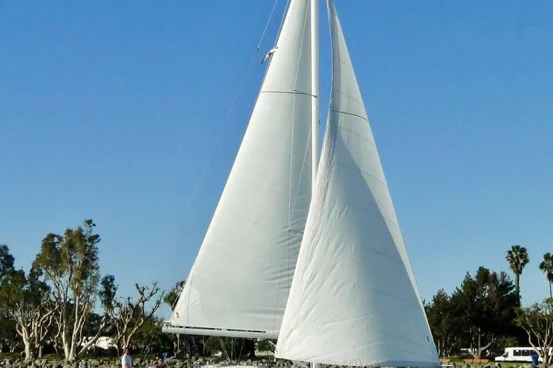 Slide: The Image of 2018 Elan 45 Impressions sailboat with white sails against a clear blue sky. - 4
