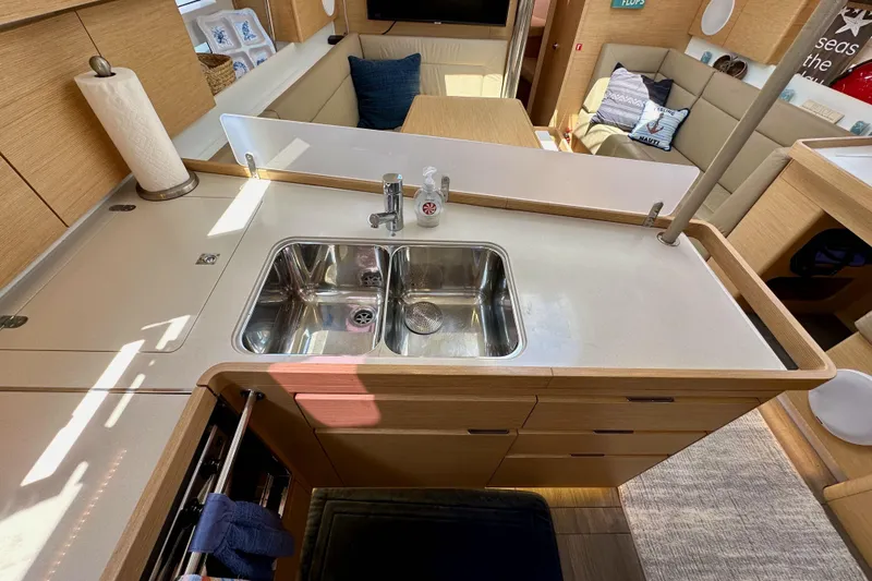Slide: The Image of Modern kitchen interior of 2018 Elan 45 Impressions yacht with double sink and cozy seating area. - 49