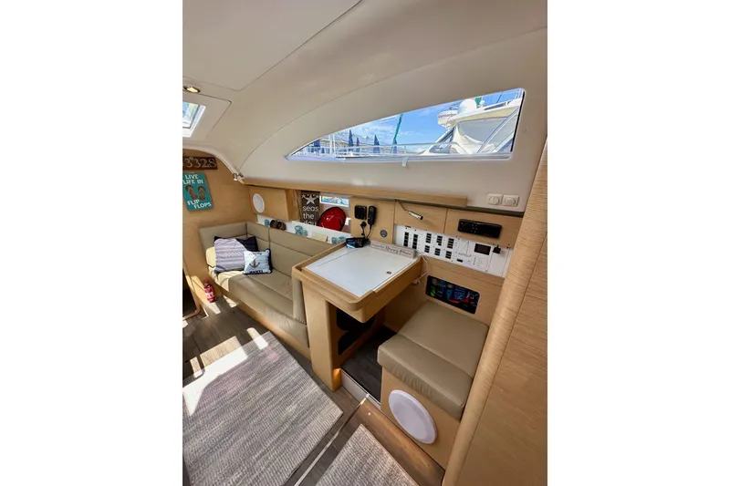 Slide: The Image of Interior of 2018 Elan 45 Impressions yacht, featuring cozy seating and navigation controls. - 57