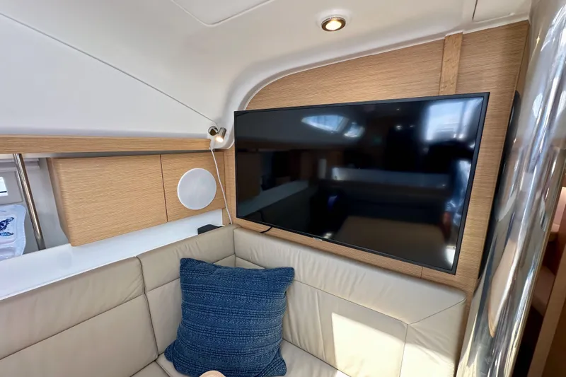 Slide: The Image of Interior of 2018 Elan 45 Impressions yacht with TV and beige seating area. - 65