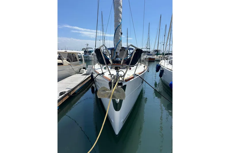 Slide: The Image of 2018 Elan 45 Impressions yacht docked in marina, clear sky, calm water. - 7