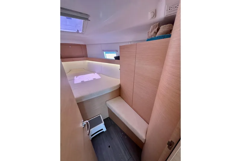 Slide: The Image of 2018 Elan 45 Impressions yacht cabin with cozy bed and wooden interior. - 71