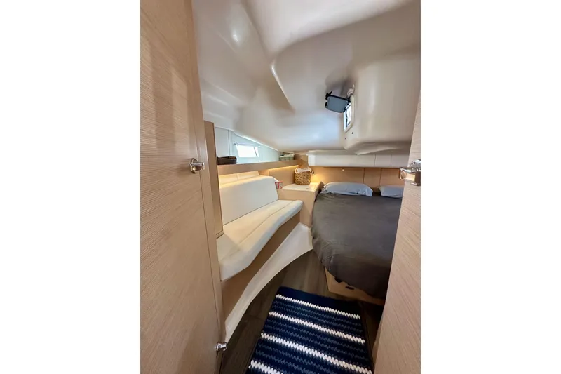 Slide: The Image of Interior of 2018 Elan 45 Impressions yacht, featuring cozy cabin with bed and seating. - 79