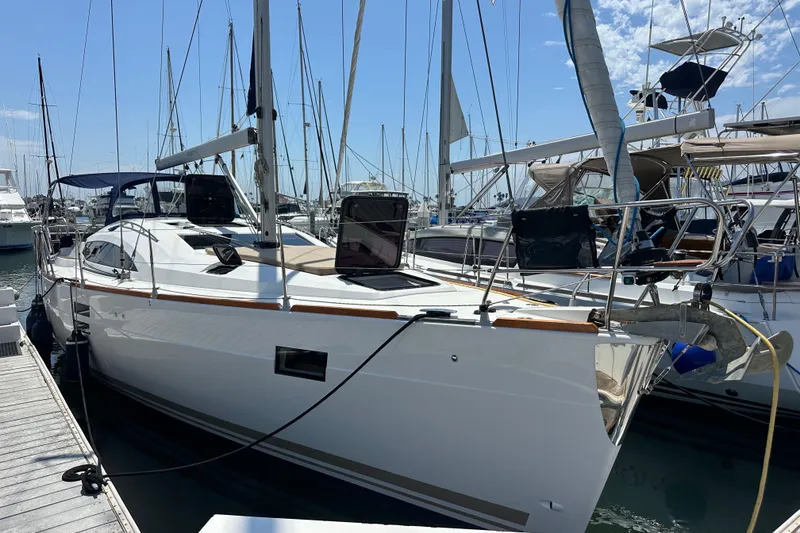 Slide: The Image of 2018 Elan 45 Impressions yacht docked at a marina under a clear blue sky. - 8