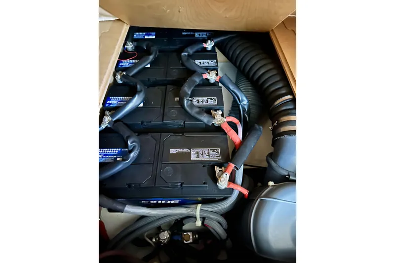 Slide: The Image of Battery compartment of 2018 Elan 45 Impressions yacht, featuring Exide batteries and wiring. - 86