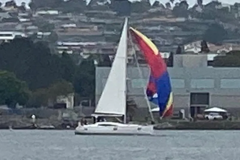 Slide: The Image of Sailboat Elan 45 Impressions 2018 with colorful spinnaker on a calm waterway. - 89
