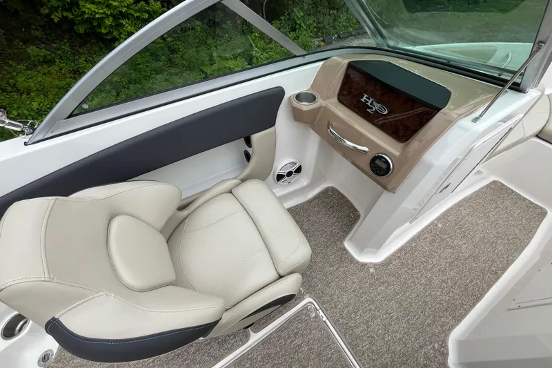 Slide: The Image of Interior of 2014 Chaparral 18 H2O Ski & Fish boat with beige seating and dashboard. - 14