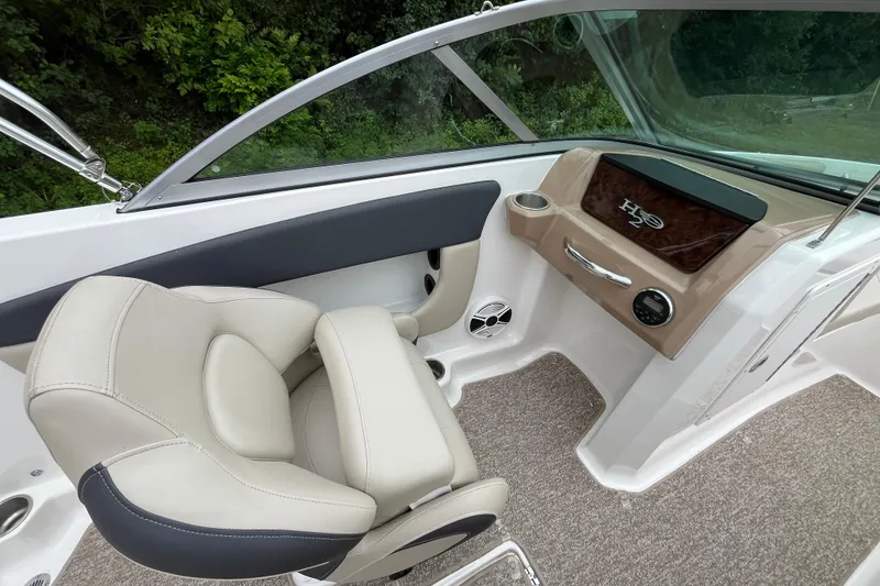 Slide: The Image of 2014 Chaparral 18 H2O Ski & Fish boat interior with beige seating and dashboard. - 15