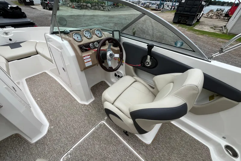 Slide: The Image of 2014 Chaparral 18 H2O Ski & Fish boat interior with steering wheel and seating. - 17