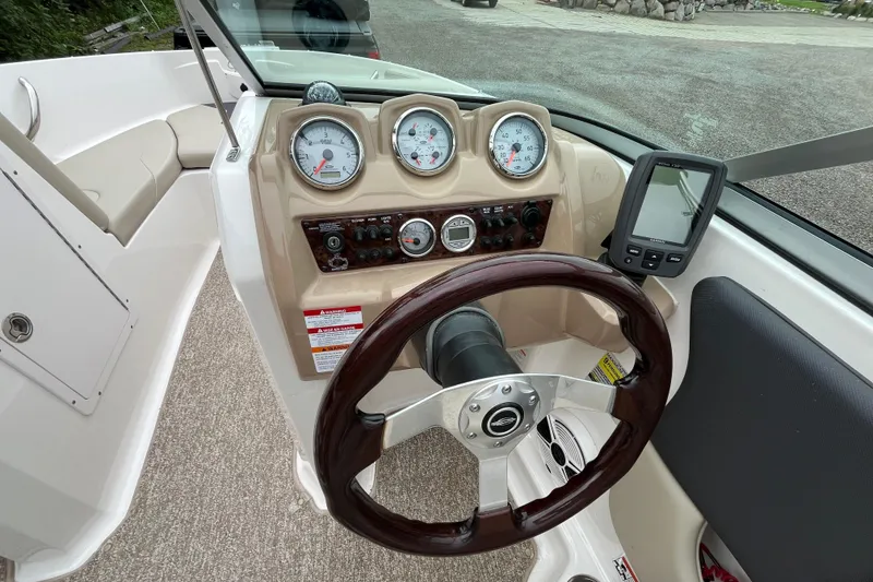 Slide: The Image of 2014 Chaparral 18 H2O Ski & Fish boat dashboard with gauges and steering wheel. - 19