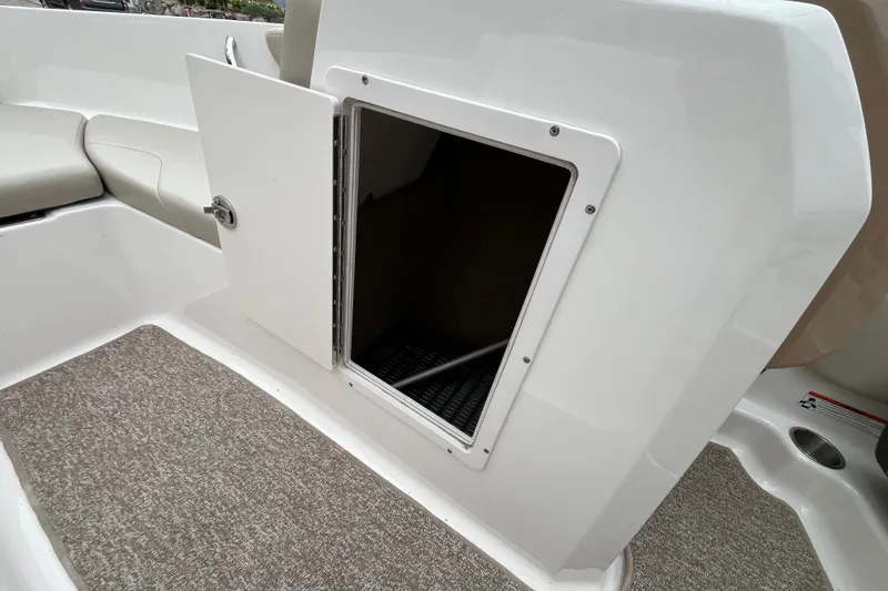 Slide: The Image of 2014 Chaparral 18 H2O Ski & Fish boat storage compartment with open hatch. - 23