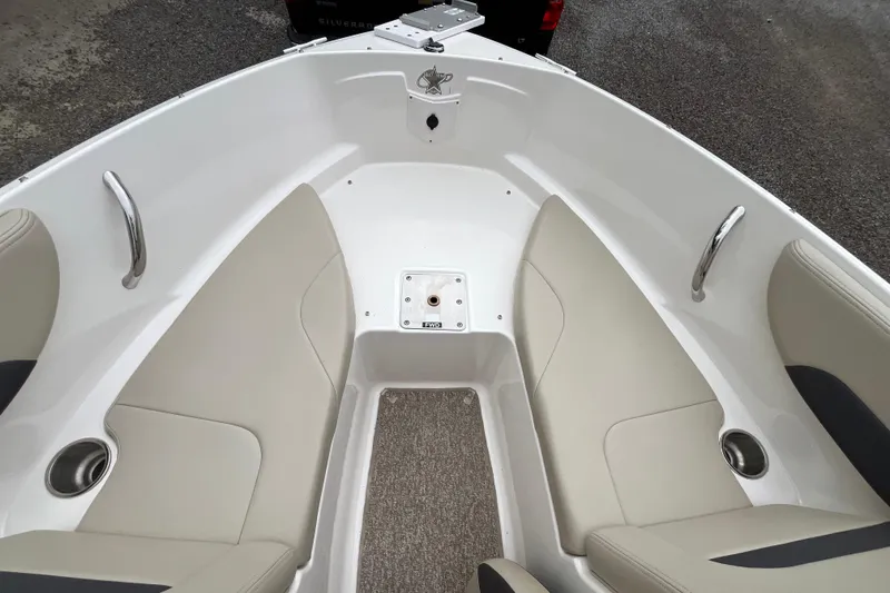 Slide: The Image of 2014 Chaparral 18 H2O Ski & Fish boat interior with beige seating and cup holders. - 29