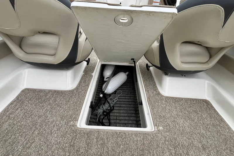 Slide: The Image of 2014 Chaparral 18 H2O Ski & Fish boat interior storage compartment with accessories. - 30