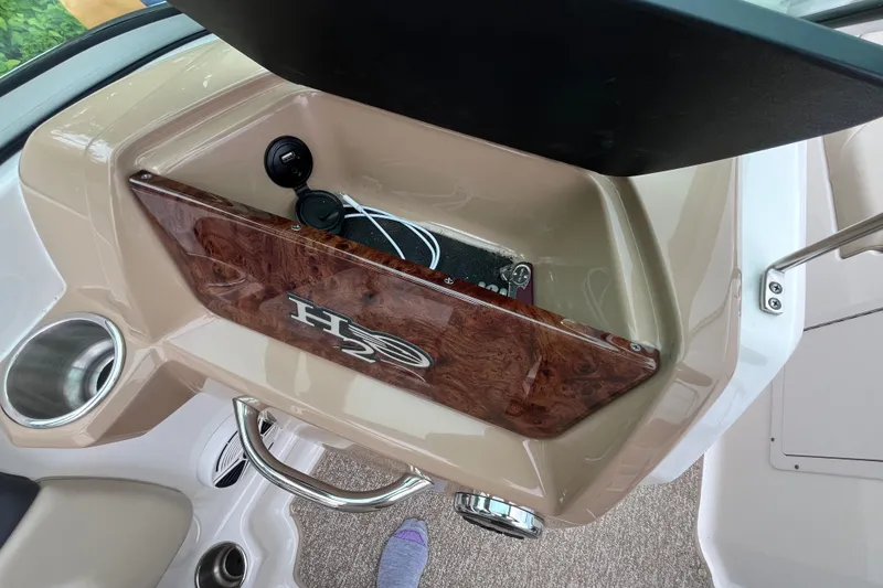 Slide: The Image of 2014 Chaparral 18 H2O Ski & Fish dashboard with wood panel and cup holder. - 33