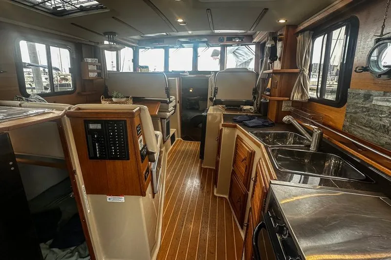 Slide: The Image of Interior of 2015 Ranger Tugs R-31 S, featuring wood accents and modern amenities. - 4