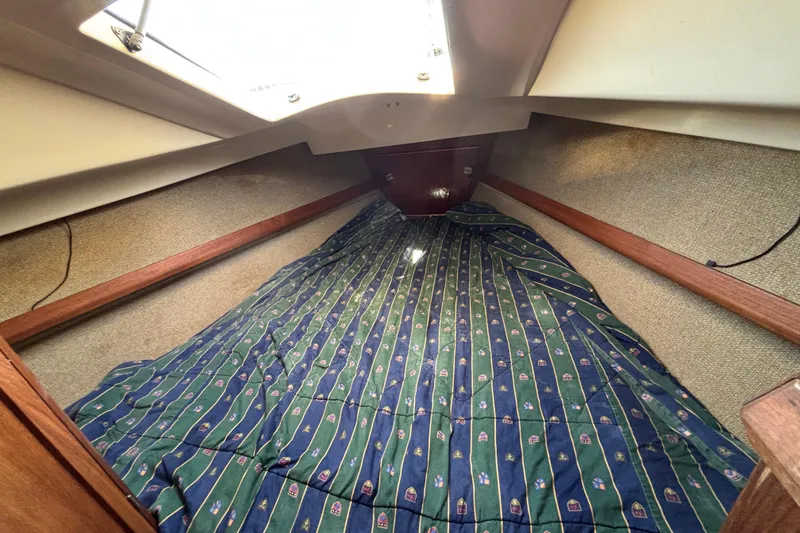 Slide: The Image of Cozy cabin interior of 1981 O'Day 34 sailboat with patterned bedding. - 13