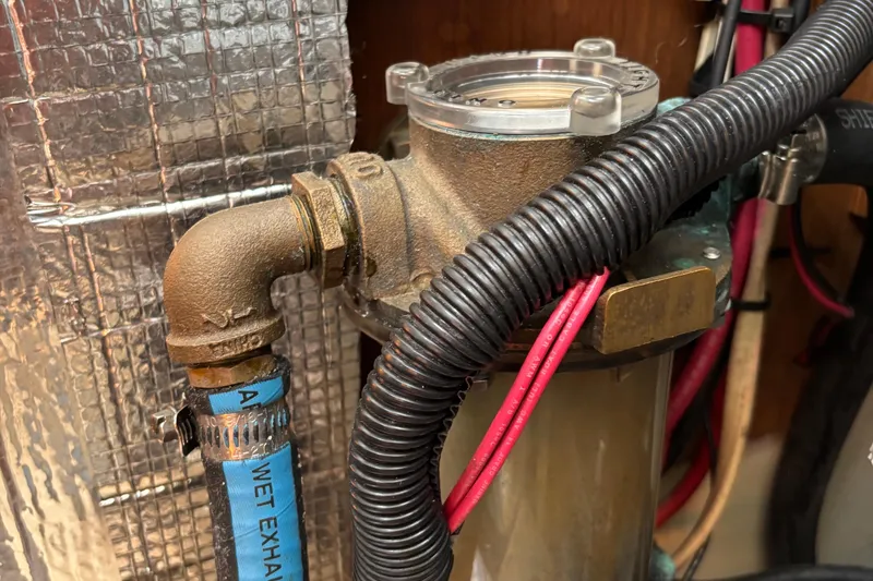 Slide: The Image of Engine compartment of a 1981 O'Day 34 sailboat, showing exhaust and wiring. - 16