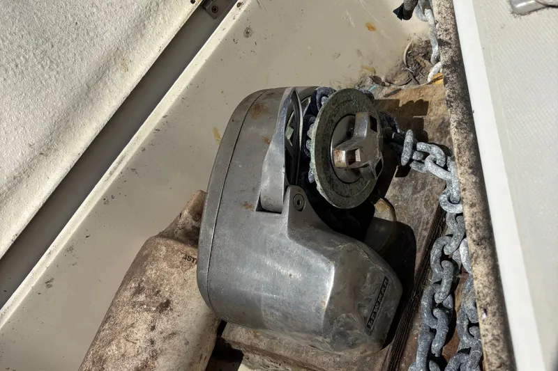 Slide: The Image of Anchor windlass on 1981 O'Day 34 sailboat with chain and weathered surfaces. - 18