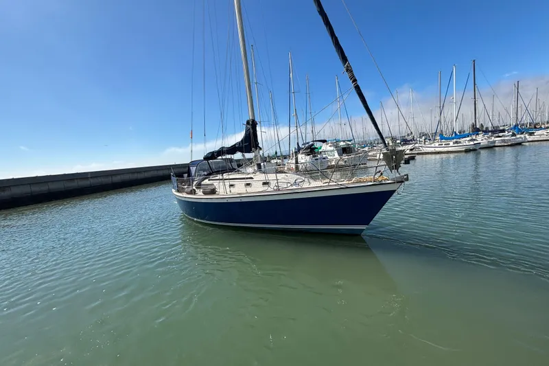 Slide: The Image of 1981 O'Day 34 sailboat docked in a marina under clear blue skies. - 3