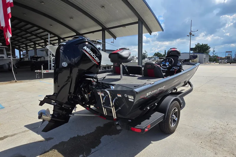 Slide: The Image of 2022 Ranger RT178 boat with Mercury engine, parked outdoors under a canopy. - 3