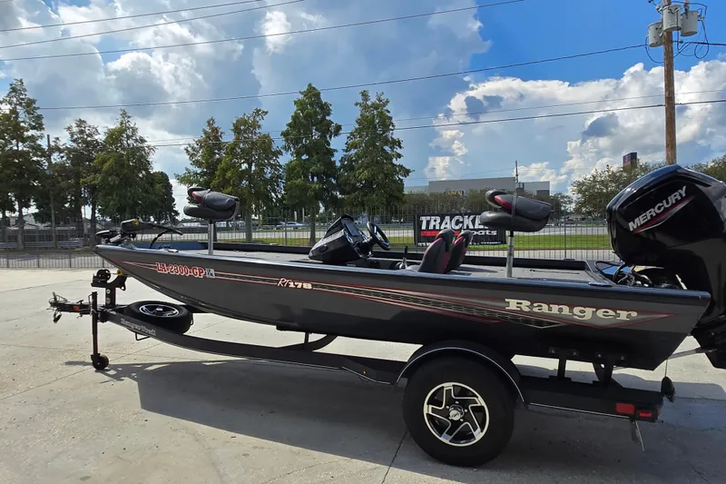 Slide: The Image of 2022 Ranger RT178 boat with Mercury engine on trailer, parked outdoors under a blue sky. - 5
