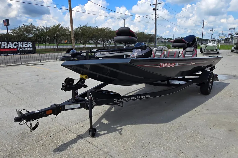 Slide: The Image of 2022 Ranger RT178 boat on trailer, parked outdoors under a cloudy sky. - 6