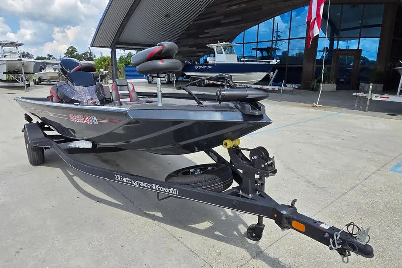 Slide: The Image of 2022 Ranger RT178 boat on trailer, parked outside a showroom with other boats. - 7