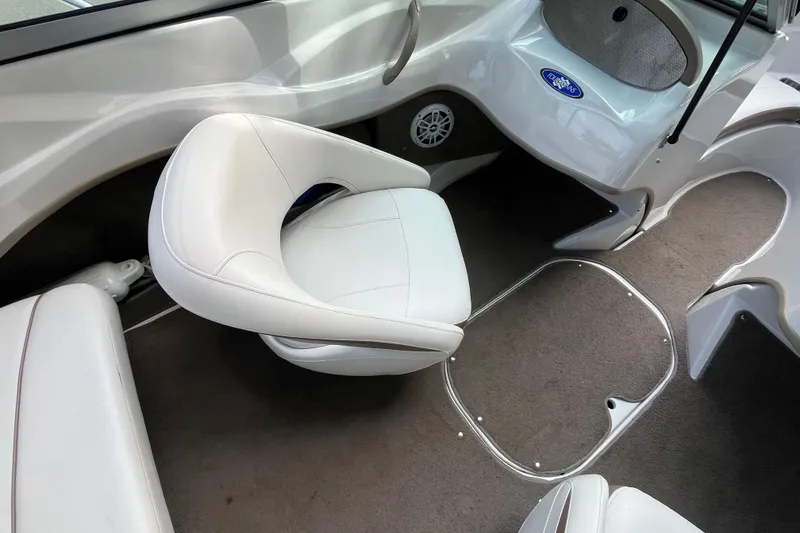 Slide: The Image of Interior of 2008 Four Winns H180 boat with white seating and carpeted floor. - 10