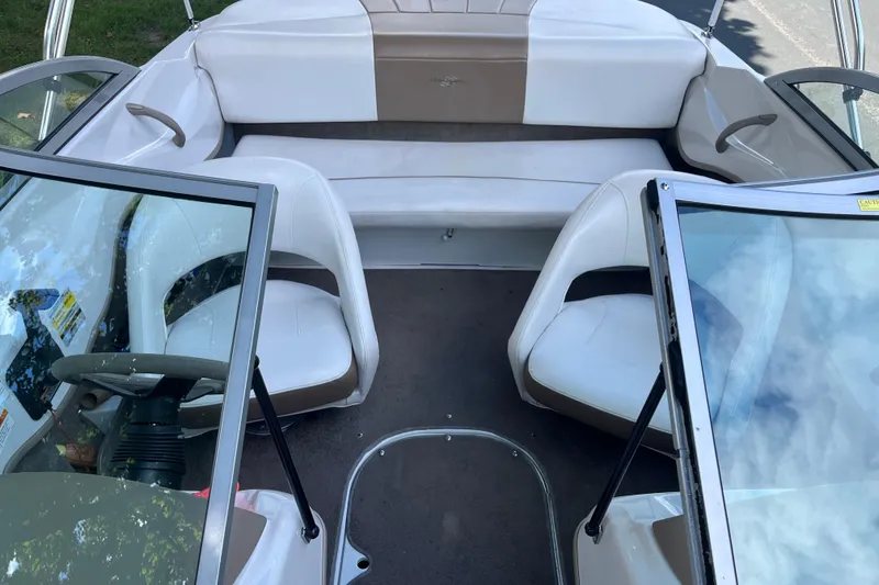 Slide: The Image of 2008 Four Winns H180 boat interior with white seating and windshield view. - 13