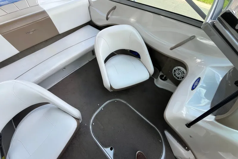 Slide: The Image of Interior of 2008 Four Winns H180 boat with white seating and carpeted floor. - 14