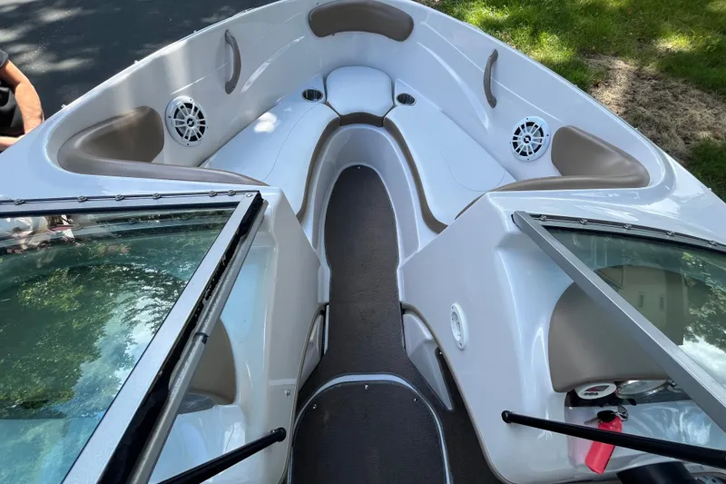 Slide: The Image of 2008 Four Winns H180 boat interior with seating and speakers, viewed from the bow. - 15