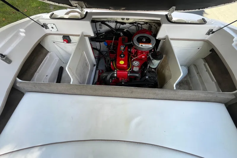 Slide: The Image of 2008 Four Winns H180 boat engine compartment with red engine components. - 17