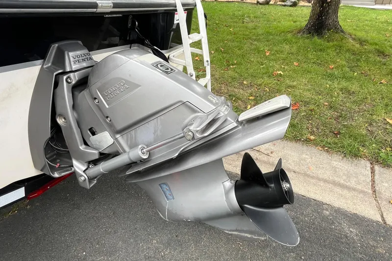 Slide: The Image of 2008 Four Winns H180 boat with Volvo Penta outboard motor, parked on pavement. - 19