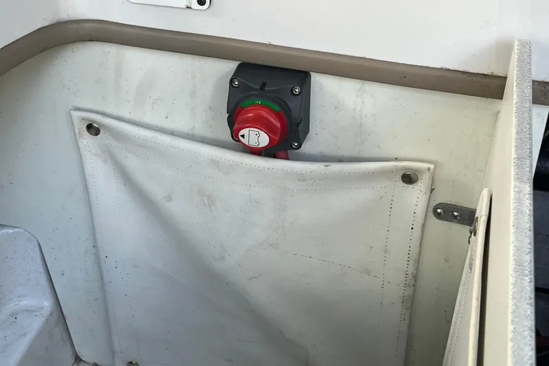 Slide: The Image of 2008 Four Winns H180 boat battery switch and storage compartment. - 21