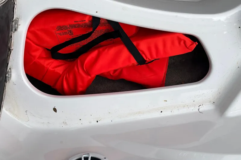 Slide: The Image of Red life jacket in storage compartment of 2008 Four Winns H180 boat. - 22