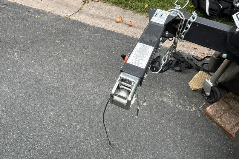 Slide: The Image of Trailer hitch of a 2008 Four Winns H180 boat on asphalt pavement. - 25