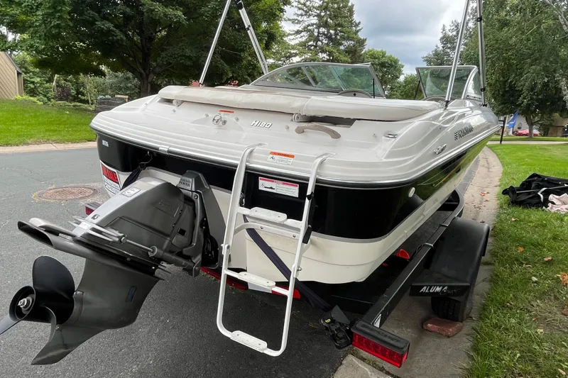 Slide: The Image of 2008 Four Winns H180 boat on trailer, rear view with ladder and outboard motor. - 4
