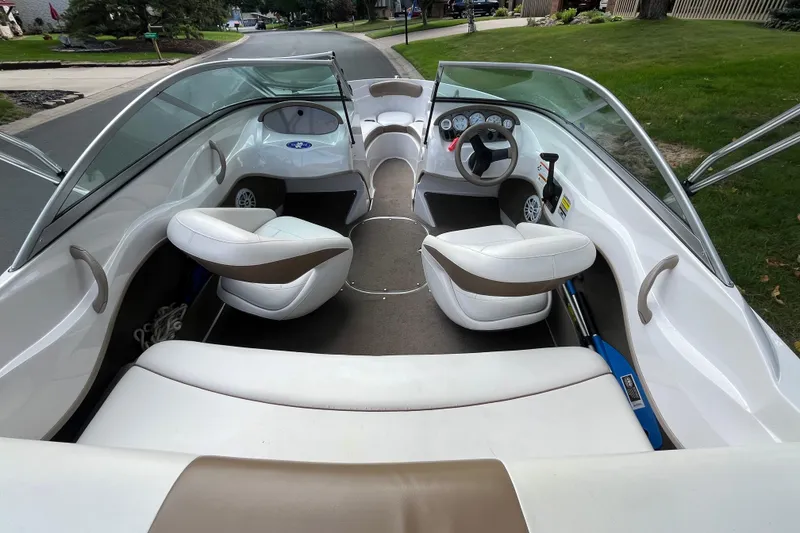 Slide: The Image of Interior view of 2008 Four Winns H180 boat with white seating and steering console. - 6