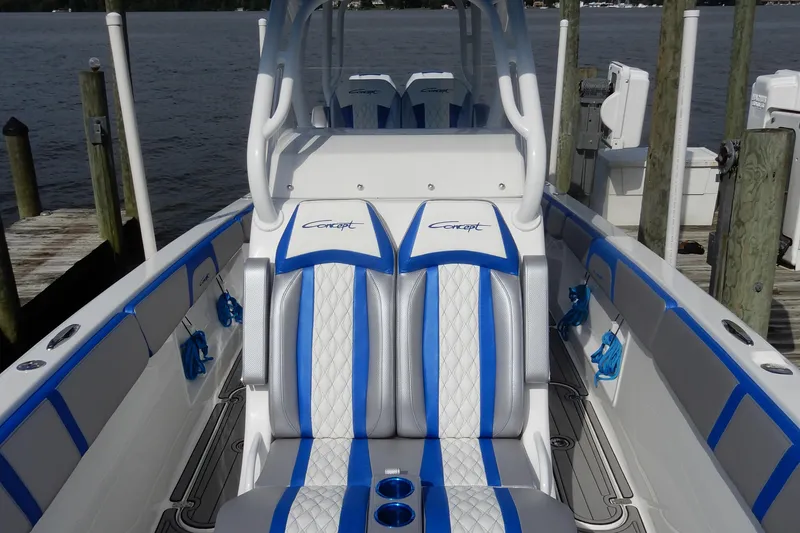 Slide: The Image of 2021 Concept 32' Open Deck boat with blue and white seating at a dock. - 11