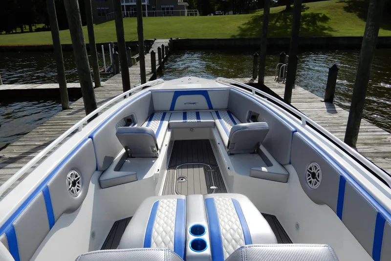 Slide: The Image of 2021 Concept 32' Open Deck boat with blue and gray seating, docked by a wooden pier. - 12