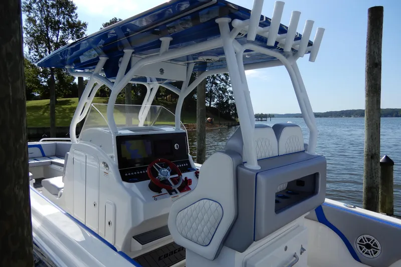 Slide: The Image of 2021 Concept 32' Open Deck boat with modern helm, docked by a scenic lake. - 18