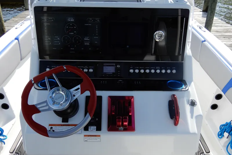 Slide: The Image of 2021 Concept 32' Open Deck boat dashboard with red steering wheel and control panel. - 22